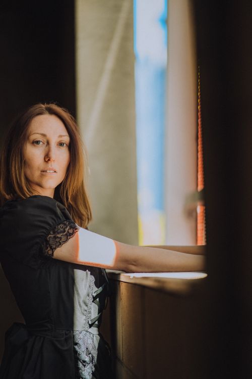 Woman Standing Beside a Window · Free Stock Photo