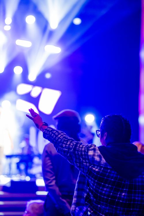 Free Dynamic club scene with vibrant lights and people enjoying music at night. Stock Photo