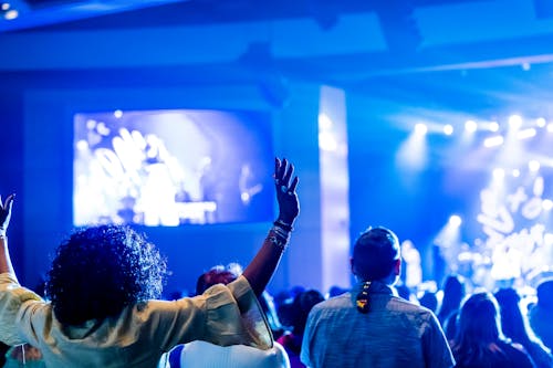 People Dancing in Neon Lights on Concert