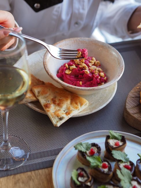 Bright pink hummus blended with roasted beet and tangy feta, a colorful twist on the classic chickpea dip.