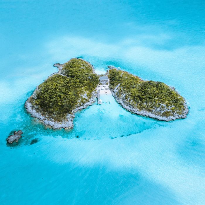 Aerial view of a green island surrounded by turquoise water