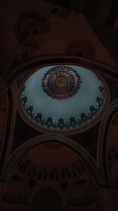 Free A stunning low angle view of an ornamented mosque dome, showcasing intricate Islamic patterns. Stock Photo