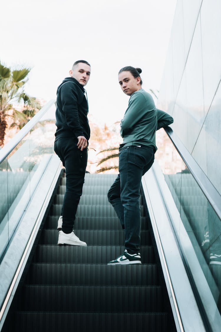 Men Going Up On An Escalator