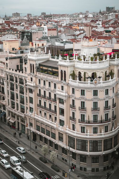Free Aerial view of Madrid's classic architecture with bustling streets below, capturing urban life. Stock Photo