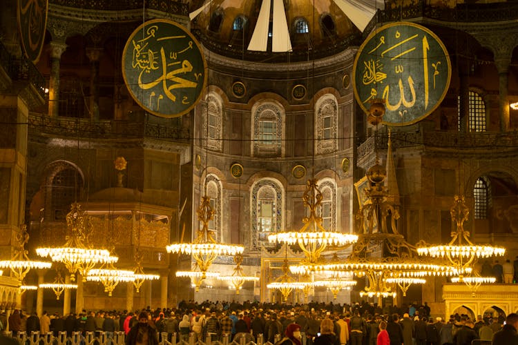 Illuminated And Crowded Interior Of Big Muslim Mosque