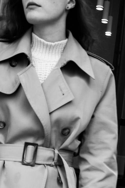 A Grayscale of a Woman Wearing a Trench Coat · Free Stock Photo