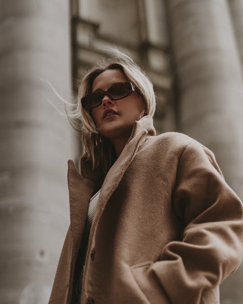 Woman in Brown Coat Wearing Sunglasses