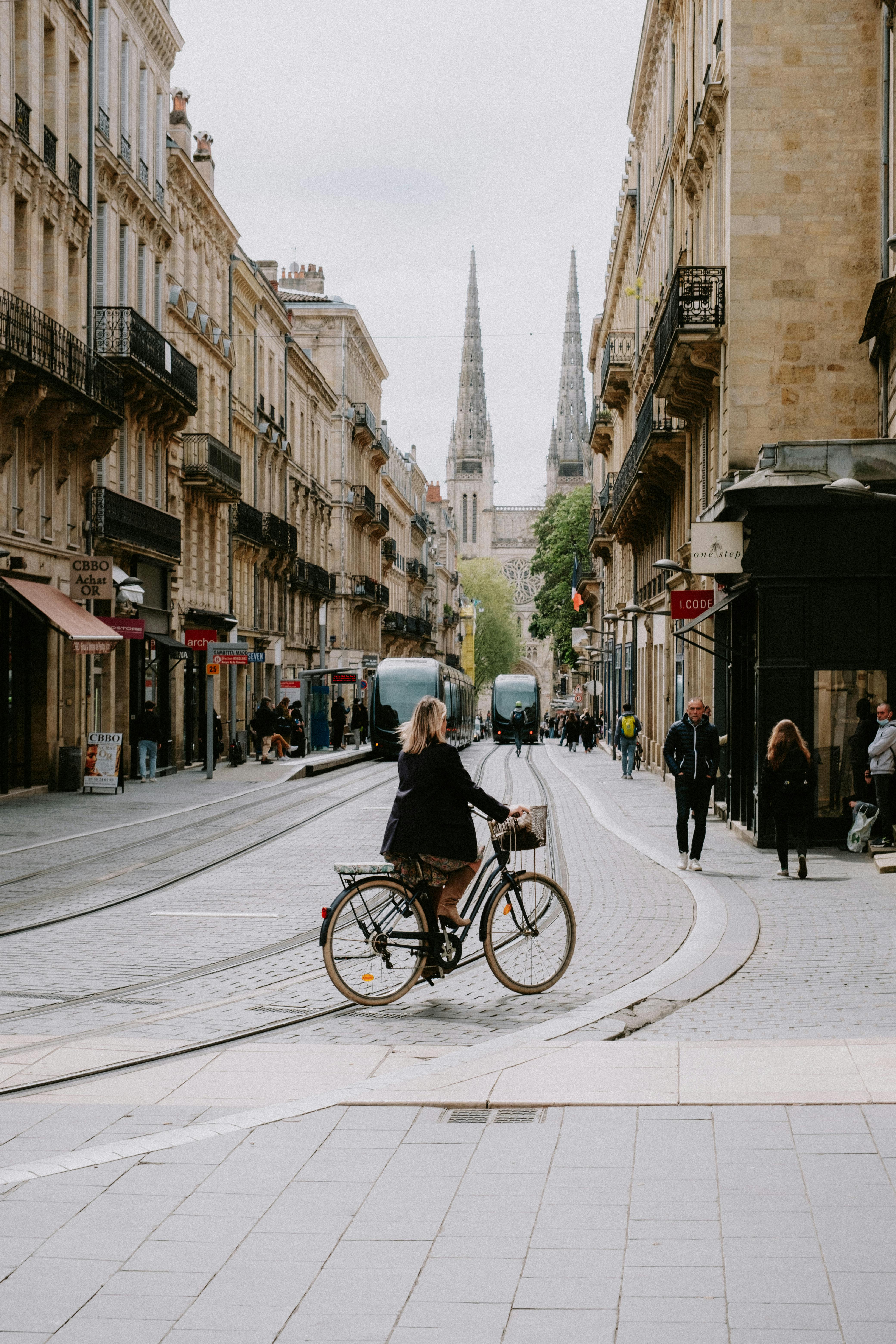 woman riding a bike along city street