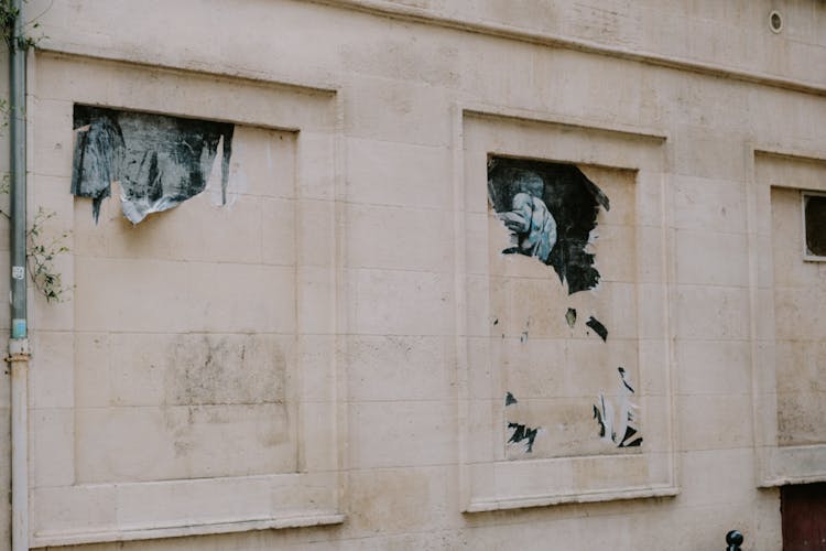 Close-up Of A Wall With Ripped Posters