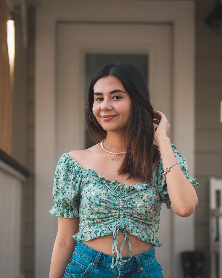 Portrait Of Smiling Woman In Flower Patterned Top