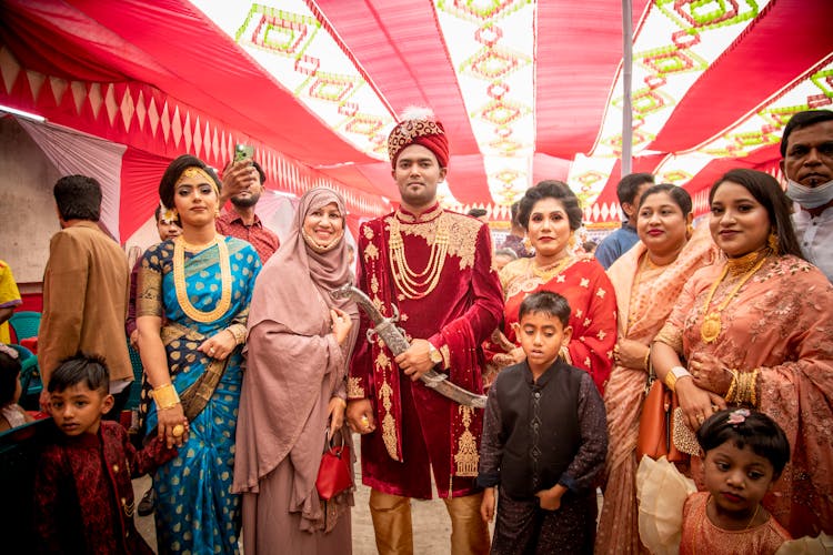 Family In Traditional Clothing Posing At Wedding