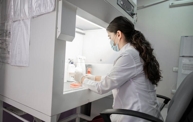 A Woman Wearing A Lab Coat In A Laboratory