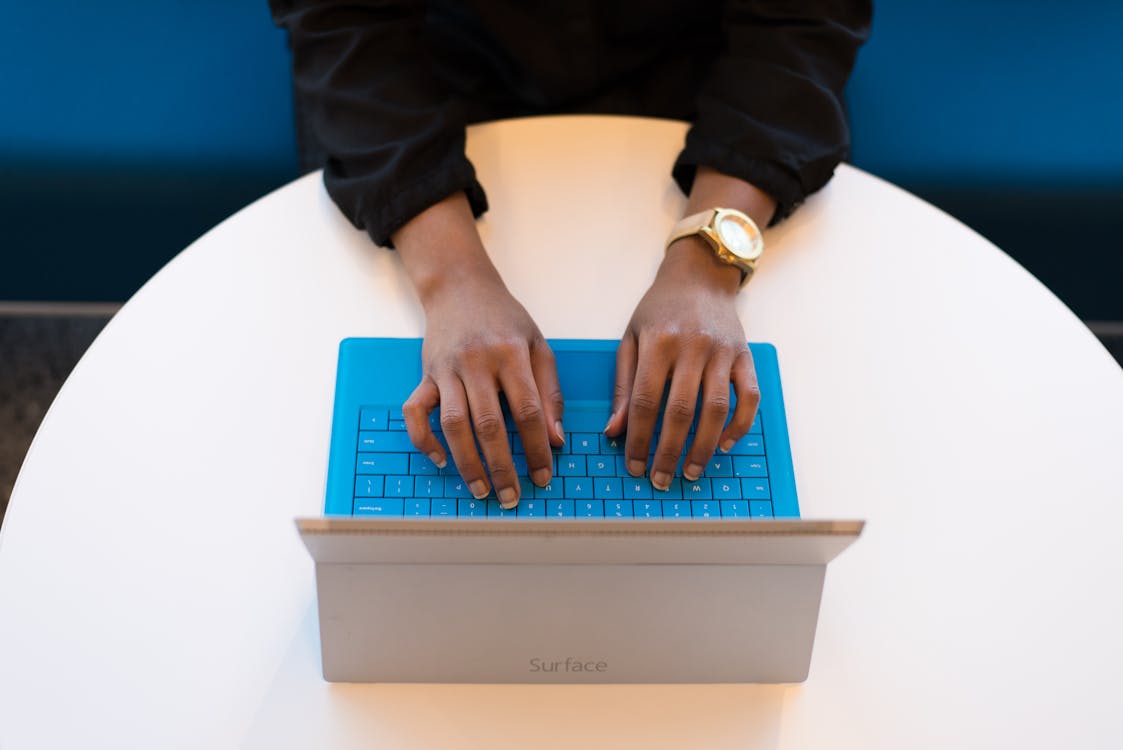 Person typing on a laptop doing research