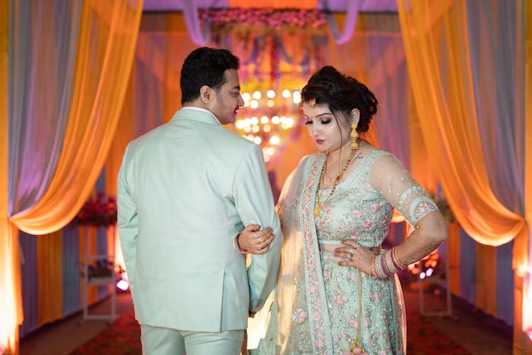 Newlywed Couple Standing With Linked Arms