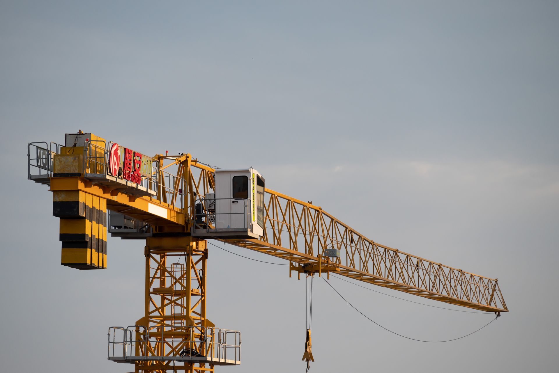 A tower crane silhouetted against a cloudy sky in Nantong, Jiangsu Province, China.