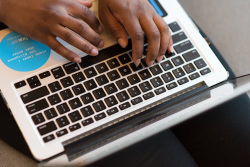 Free Person Using Silver Laptop Computer Stock Photo