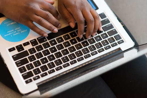 Person Using Silver Laptop Computer