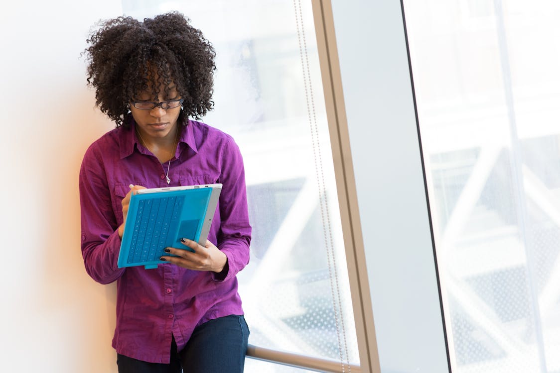 Woman Wearing Purple Long-sleeved Shirt Standing Near Window