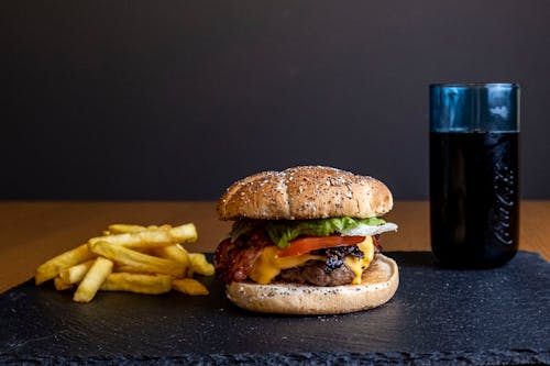 Burger and French Fries Beside a Drink