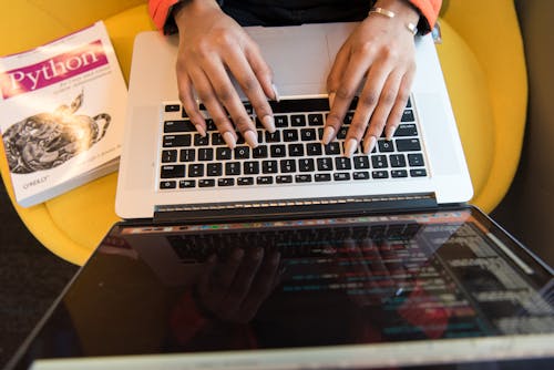 Free Woman Typing On Macbook Pro Stock Photo