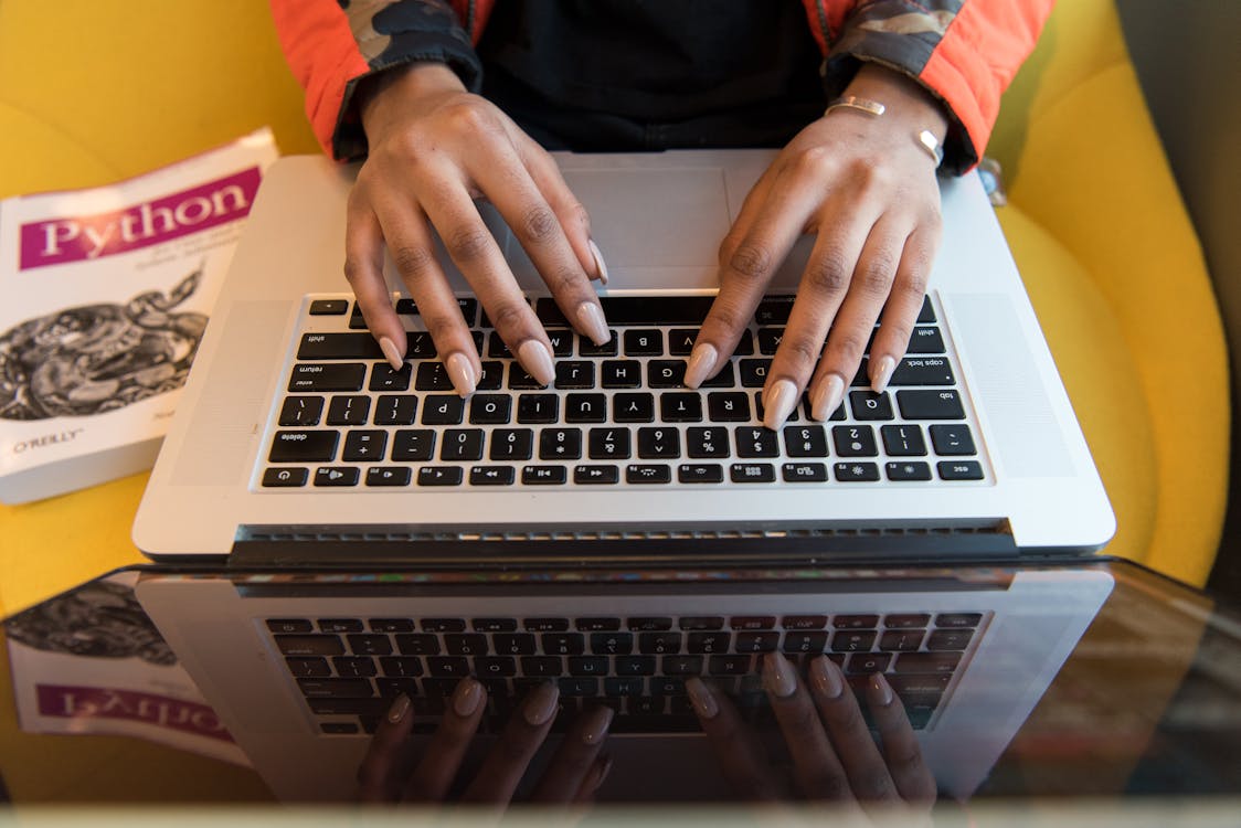 Free Person Typing On Macbook Pro Stock Photo