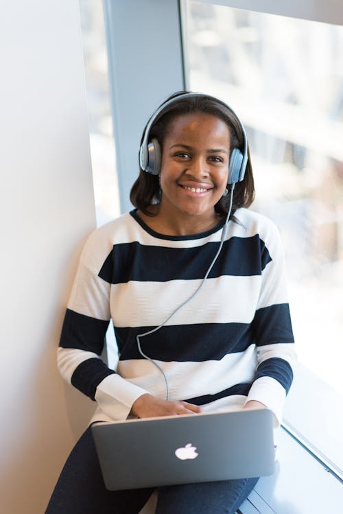 Woman Wearing White And Black Stripe Long-sleeved Shirt Holding Macbook