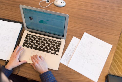 Person's Hands on Top of Macbook Air