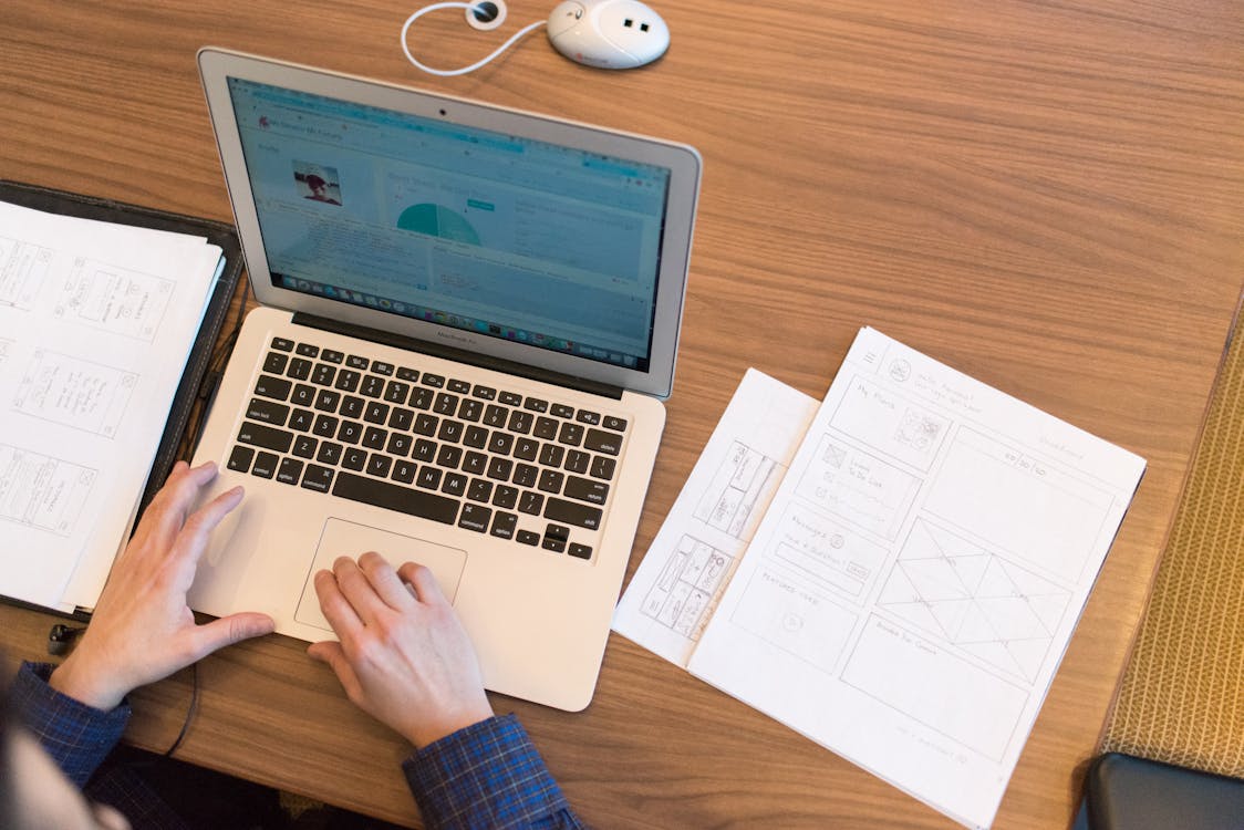 Person's Hands on Top of Macbook Air