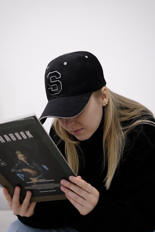 Woman in Black Cap Reading Book