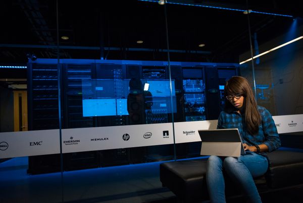 Dark data centre aisle - photo by Christina Morillo on Pexels