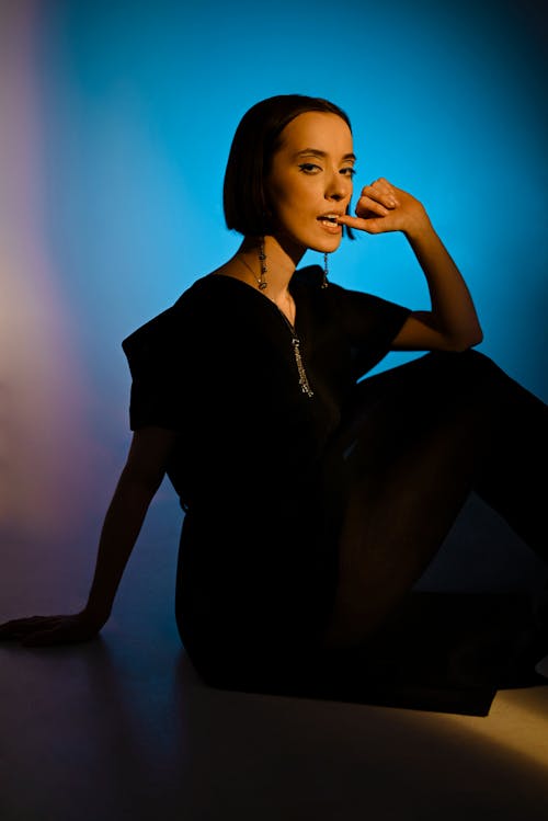 Woman in Black Outfit Sitting on the Floor