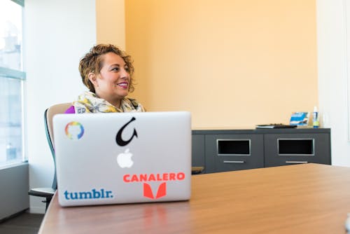 Woman Sitting Near Silver Apple Macbook