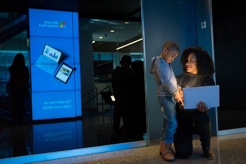 Woman Together With Children Holding Laptop Computer