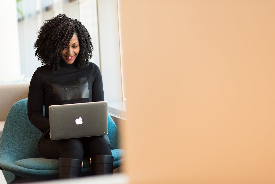 Free Woman Holding Macbook Stock Photo