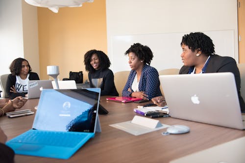 Free 3 Women Sitting at the Table With Macbook Pro Stock Photo