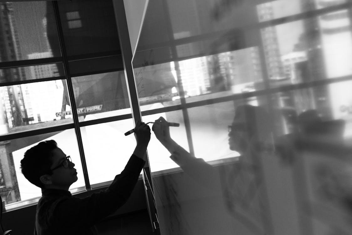 Free Grayscale Photo of Man Holding Pen Stock Photo