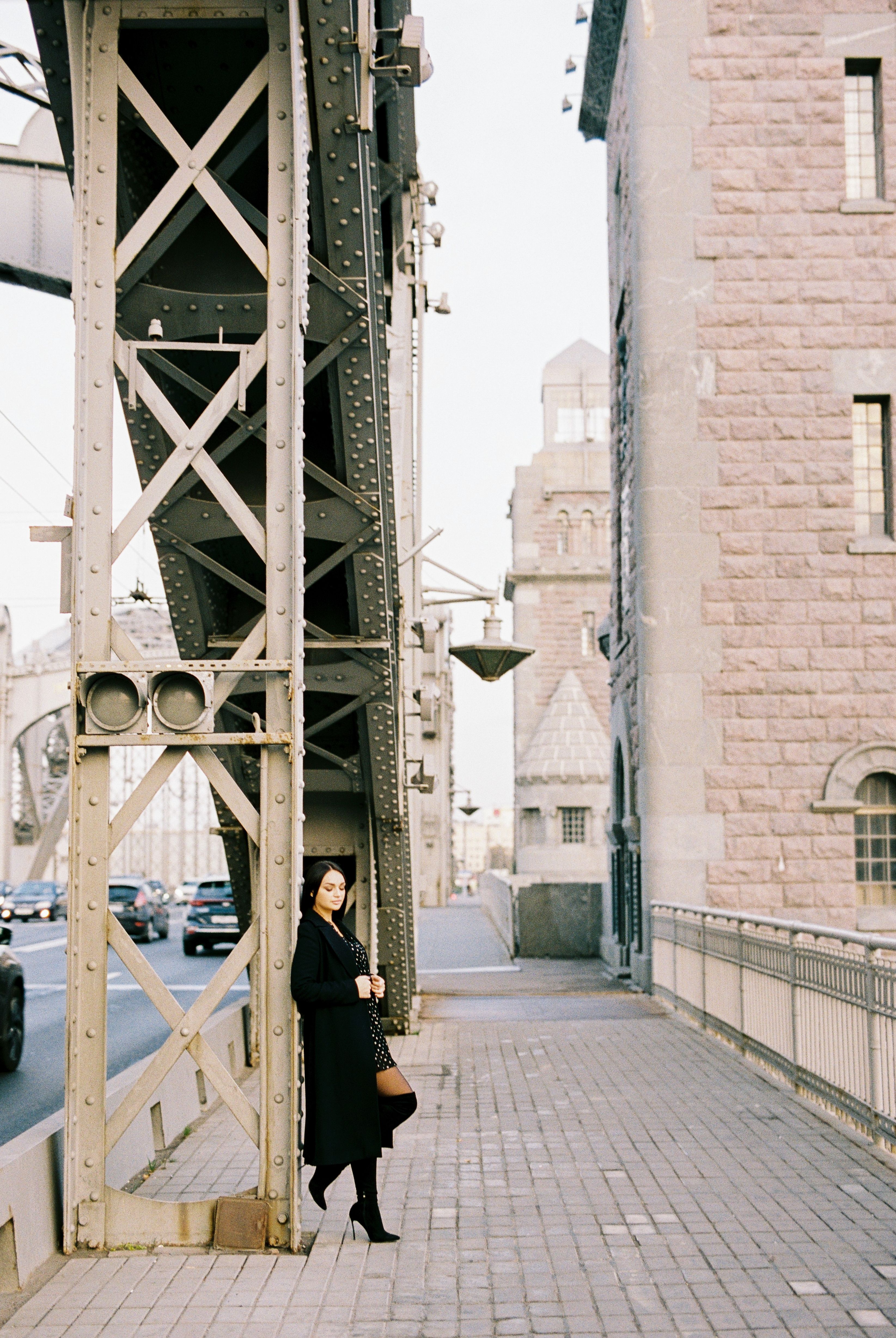 Woman in Black Coat Leaning on Metal Bridge · Free Stock Photo