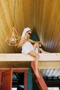 Woman in Towels and Sunglasses Sitting on Mezzanine Holding Pizza and Soda Bottle
