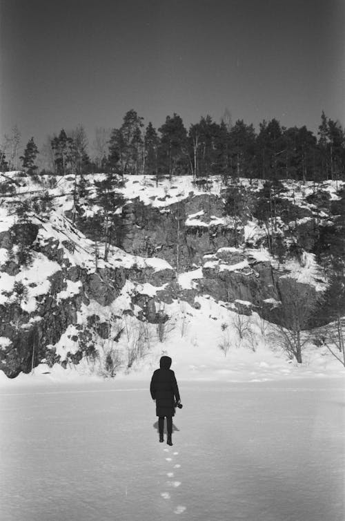 Person Walking On The Snow To the Mountains