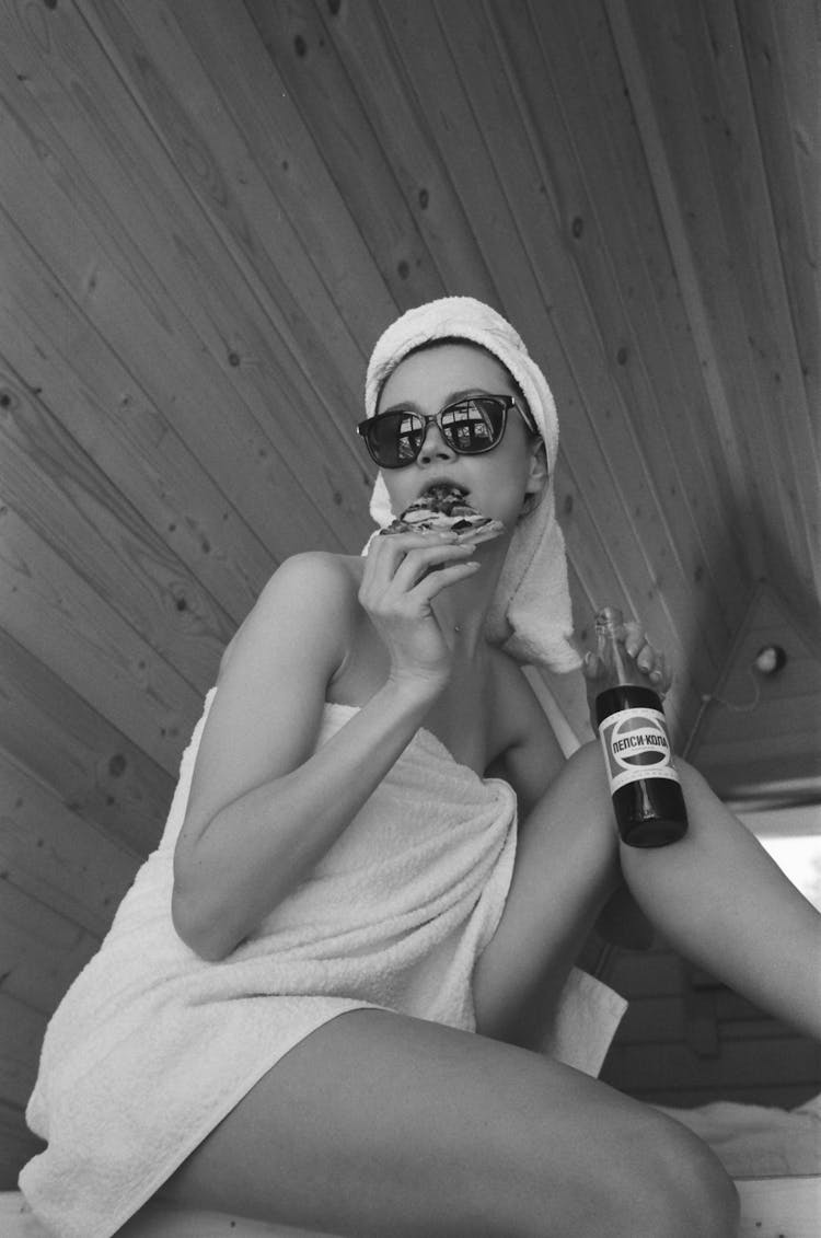 Woman In Towel Drinking Coke In Wooden Hut