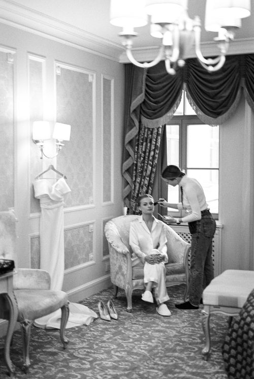 Free Black and white photo of a bride preparing for her wedding in an elegant room. Stock Photo