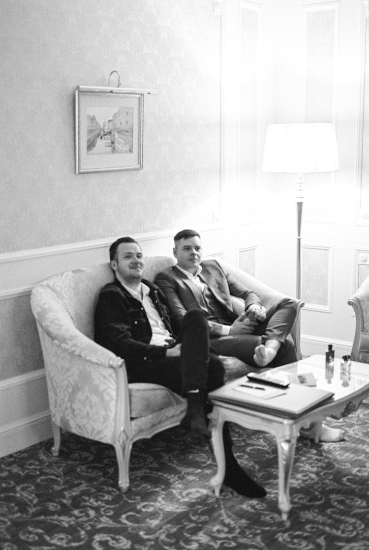 Men Sitting On Sofa In Luxury Design Room