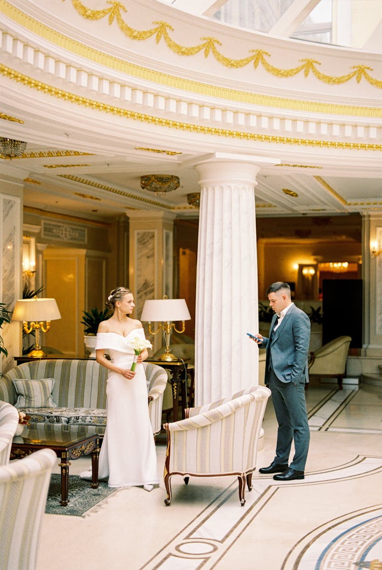 Couple Standing In The Hotel Lobby