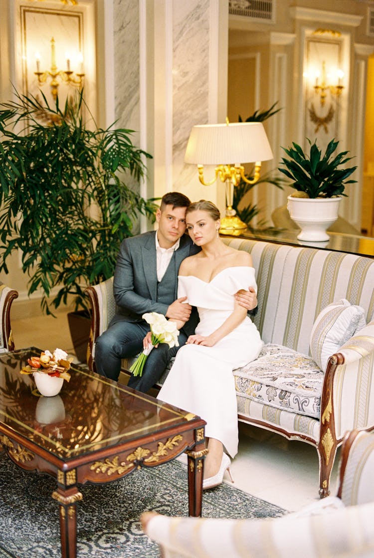 Couple Sitting In A Sofa In The Lobby