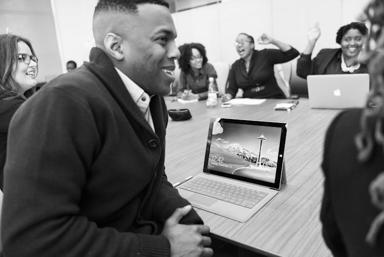 Grayscale Photo Of Group Of People Laughing