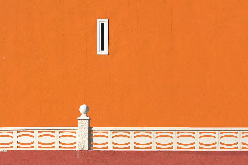 Orange rendered wall with a slot window — Jan van der Wolf on Pexels