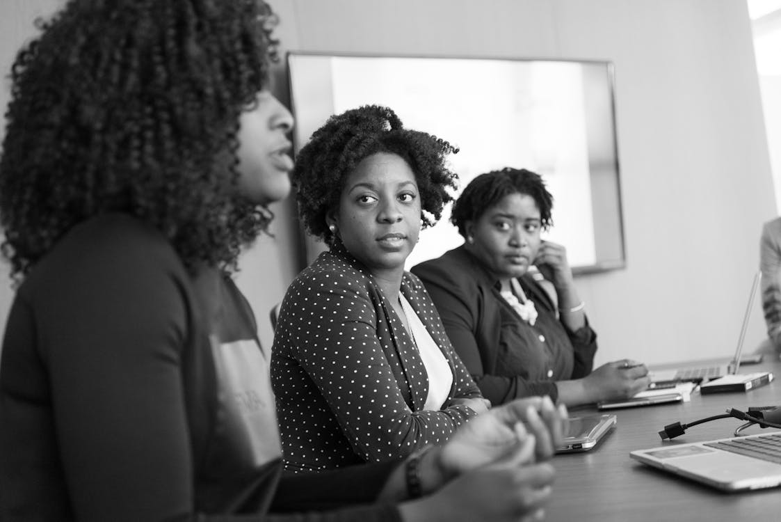 Free Woman Discussing With Her Colleagues Stock Photo