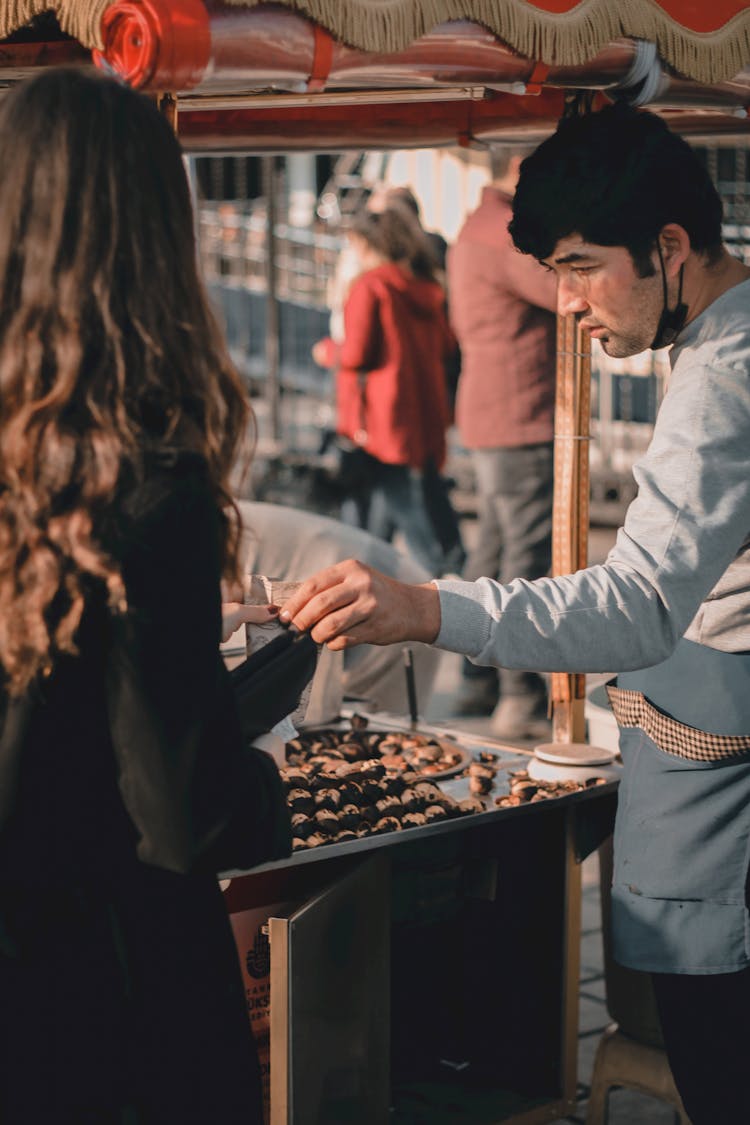 Woman Buying Food On Street Market