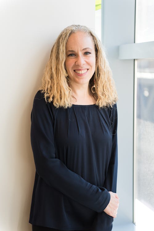 Woman Wearing Black Long-sleeved Shirt Leaning on Wall