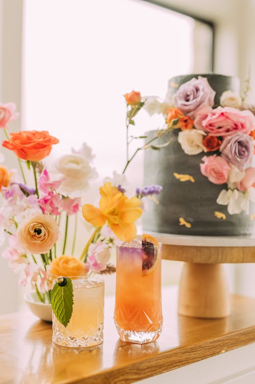 Free Cocktail Drinks Besides Flower Vases Stock Photo